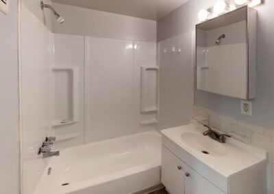 A clean bathroom featuring a sink, toilet, and shower, showcasing modern fixtures and a bright, inviting atmosphere